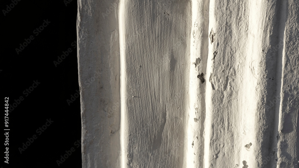 Poster white lime wall with textured edges illuminated by soft light