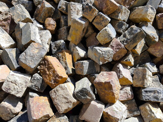 Pile of Assorted Bricks Showing Varied Textures in Natural Light at a Construction Site