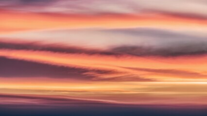 Obraz premium A plane flying through a colorful sky with clouds, AI