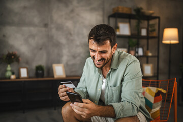 adult man have online shopping on mobile phone with credit card