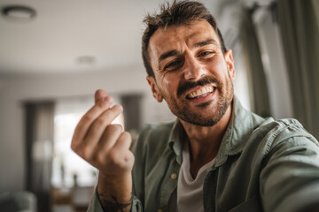 self portrait of adult excited man stand and smile at home
