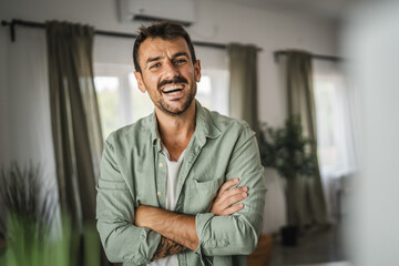 Portrait of adult man stand and smile at home