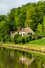 Obraz premium Charming House by Canal in French Countryside