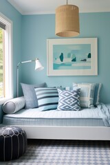 A cozy daybed with pillows and a woven pendant light, located in a light blue room.
