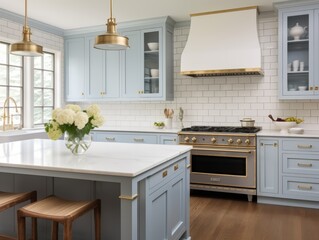 Fototapeta premium A modern kitchen with light blue cabinets, white subway tile backsplash, gold accents, and a stainless steel stove.