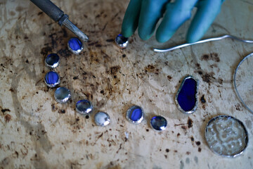 Stained glass workshop. Table with pieces of glass and necessary tools. 