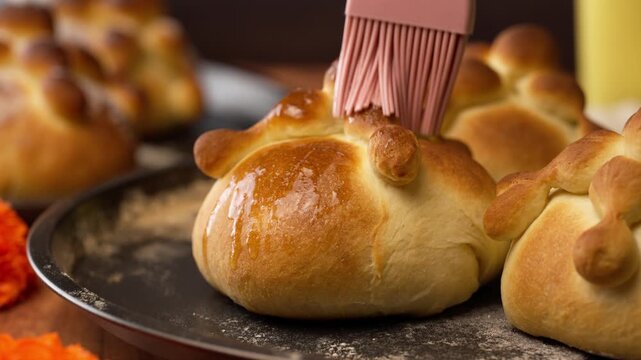 Pan de muerto or hojaldras glazed with melted butter