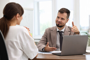 Fototapeta premium Consultant working with client at table in office. Business meeting