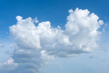 Bright blue sky with fluffy white clouds on a sunny day
