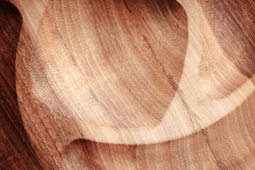 Naklejka premium The sideboard is made of wood for serving snacks, fruits, nuts, cheeses, meats and original serving of main dishes. Luxury products from hard and exotic wood species. Accessories for a modern kitchen.