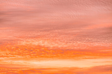 Obraz premium A beautiful sky tinted by the sun leaving vibrant shades of gold, pink, blue and multicolored. Clouds in the twilight evening and morning sky. Cloudy sky background in the evening and during the day.