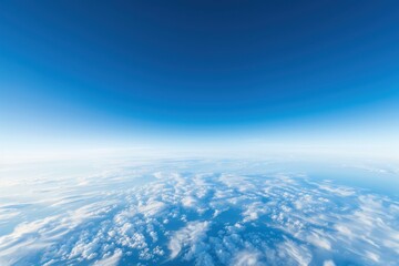 A serene aerial view of a blue sky with soft white clouds, conveying a sense of peace and tranquility in nature.