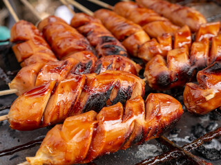 Sausages are being grilled complete with sauce and spices sold on the city streets