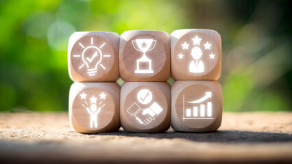 Wooden blocks with icons symbolizing consulting concepts such as success, ideas, teamwork, and growth, set against a blurred green background.