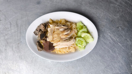 Chicken rice in a white plate on the dining table