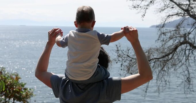 Mother Holds Son On Shoulders. Lighthouse Park, West Vancouver, British Columbia, Canada.