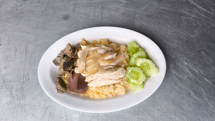 Chicken rice in a white plate on the dining table