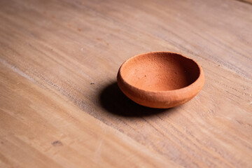 earthen pot on a wooden background