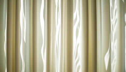 Close-up of textured cream curtains with light reflections, creating an elegant and serene ambiance