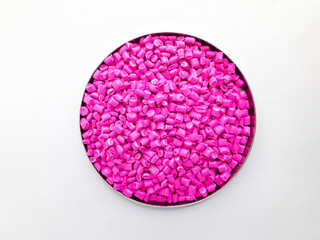 Neon pink masterbatch granules on white background. Color pigment carrier polymer in plastic...