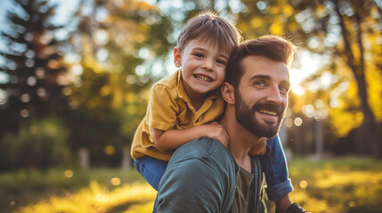 Fototapeta premium Father piggyback his son on a shoulder and walking around the park