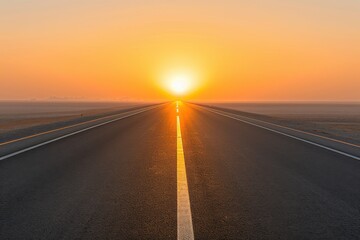 A serene road stretching towards a vibrant sunset, illuminating the horizon with warm golden hues.