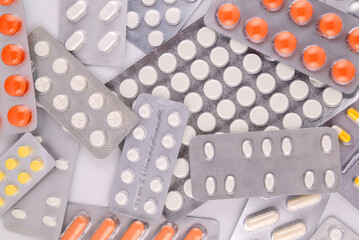 background of multi-colored tablets in blister packs