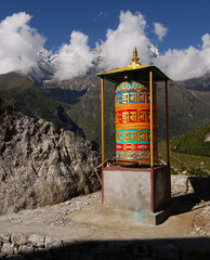 Buddhist colored prayer mill in a Himalayan valley