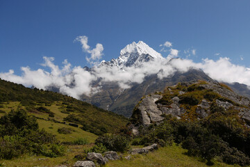 Monumental Himalayan peak with clouds around