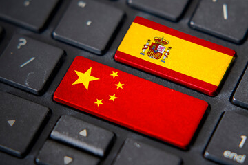 China and Spain flags on computer keyboard