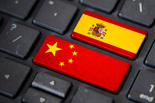 China and Spain flags on computer keyboard
