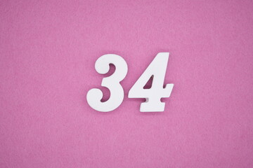 The numbers are made of white painted wood. Laying on the floor was pink paper.