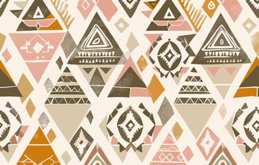 Seamless pattern with abstract geometric shapes in tribal style. Repeating texture with triangles diamonds and dots in brown beige pink and orange colors