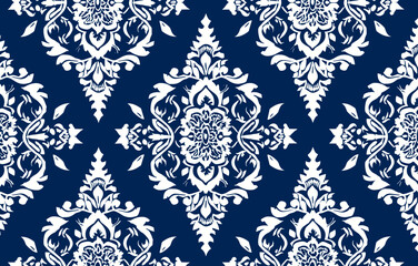 A seamless pattern of intricate white floral designs on a deep blue background ideal for textiles wallpapers and decorative projects