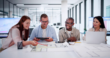 Designer Group At Desk Discussing Custom House