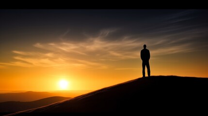 Serene Sunset Silhouette of a Person Standing on a Hill with Vibrant Colors in the Sky