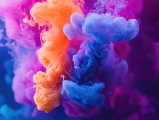 Fototapeta premium Neon ink drops in water, creating a colorful abstract background