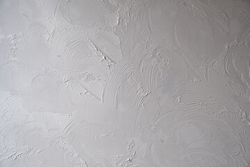 Applying decorative putty. White abstract texture of surface covered with putty