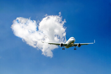 White passenger airplane flying in the sky amazing clouds in the background