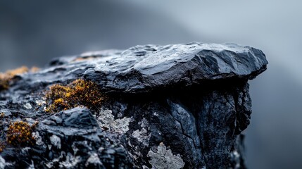  A rock's textured side, adorned with moss, against a backdrop of a dark, ominous sky
