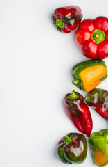 Multi-colored bell pepper on a white background. Top view, copy space.