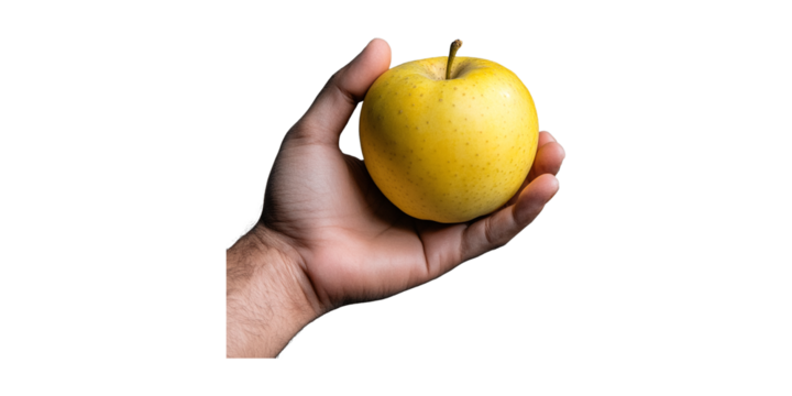 Hand holding a yellow apple isolated on transparent