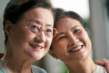 portrait of two happy senior asian women