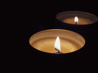 Scented candles in the dark at night for a spa or relaxation background.