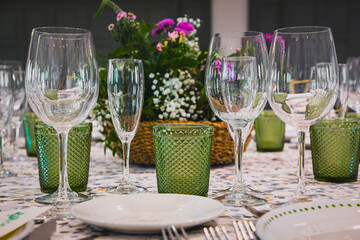 Elegant table setting with crystal glassware and floral centerpiece for formal dining.