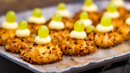 Shortbread cakes with nuts decorated with whipped cream and grapes