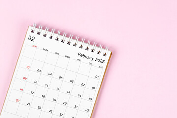 February 2025 desk calendar on pink background, Position with empty space.