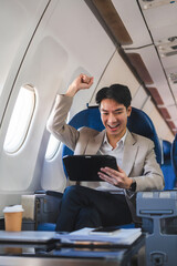 Successful business man, Airplane, travel, enjoying comfortable flight while sitting in the airplane cabin.