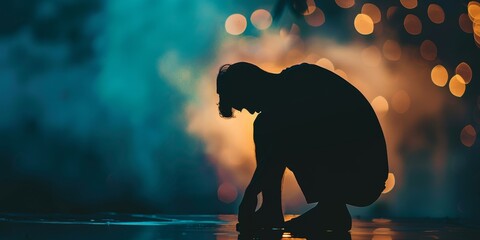 Desperate silhouette of a man leaning over, hands on knees, against a blurred, moody background, illustrating emotional distress and a feeling of being overwhelmed