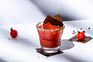 Trendy bloody mary tomato alcoholic cocktail drink with juice, spices, vodka and nori. Gray background, hard light © 5ph